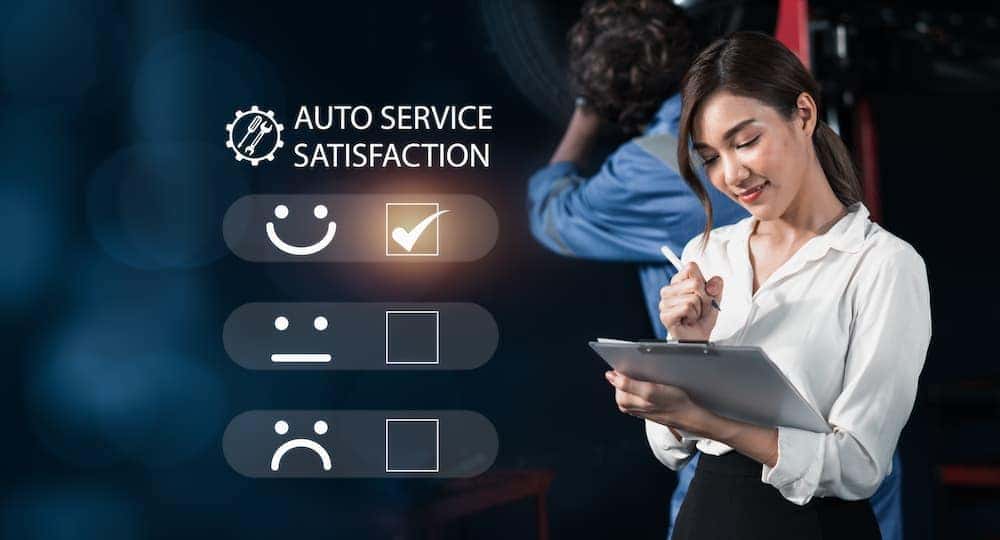 An auto service satisfaction survey is shown being filled out by a woman.