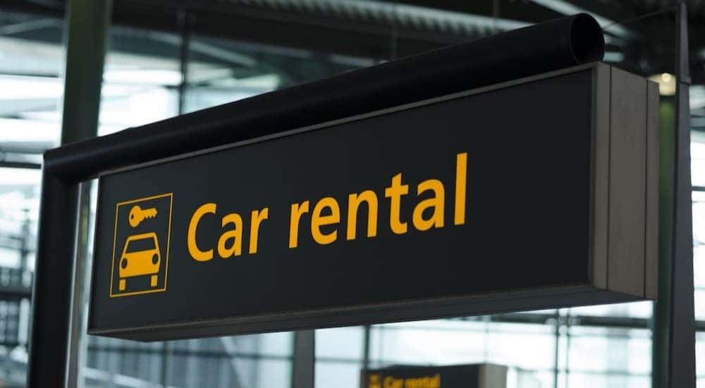 A car rental sign is shown.