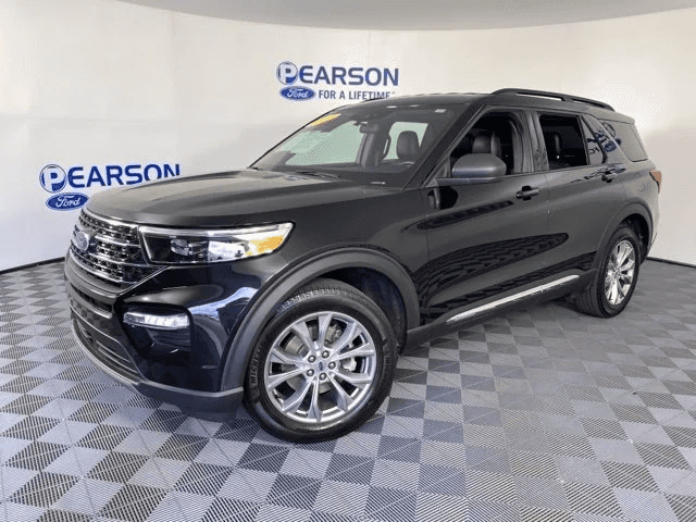 A black 2021 used Ford Explorer is shown parked in a showroom.