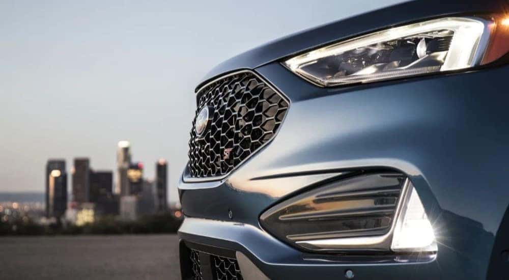 A close up shows the grille on a blue 2021 Ford Edge ST.