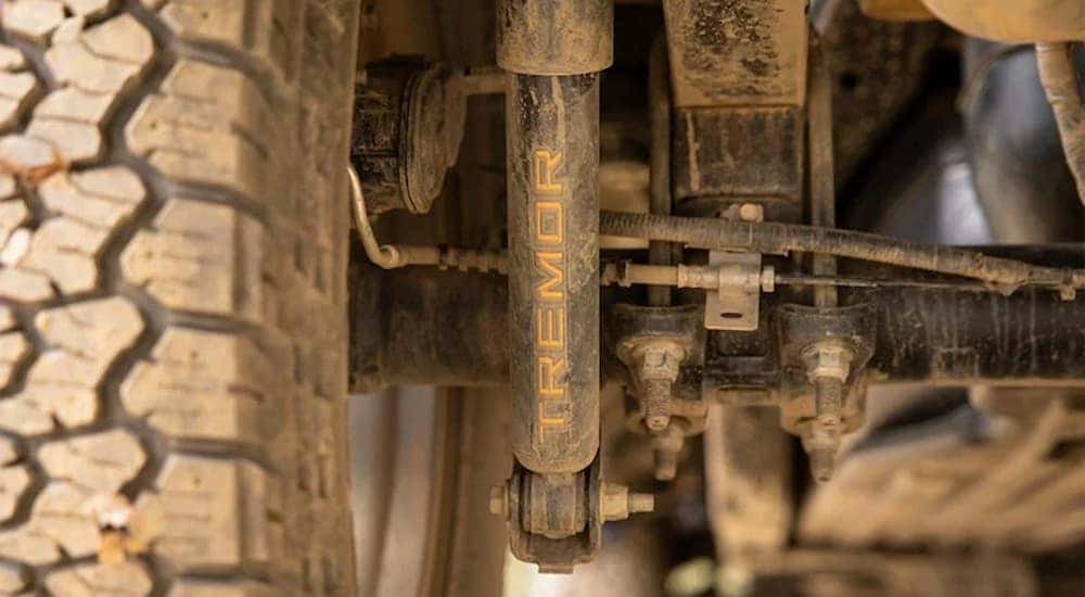 The mud covered shocks are shown on a 2022 Ford F-150 Tremor.
