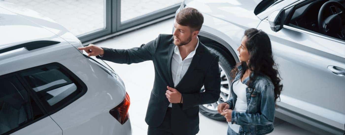 A salesman is shown speaking to customers at a Zionsville Ford dealer.