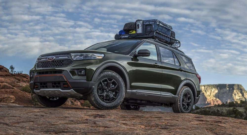 A green 2022 Ford Explorer is shown from the side in the mountains.