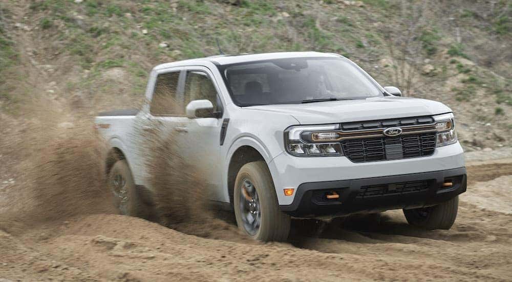 A grey 2022 Ford Maverick Tremor is shown off-roading after leaving a dealer that sells Fords near you.