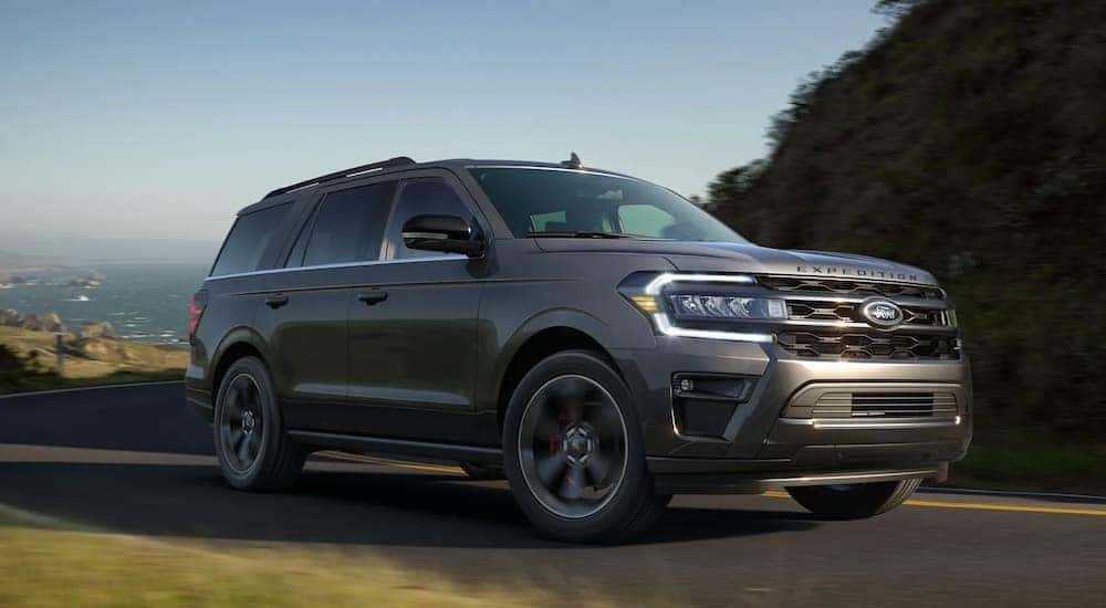 A grey 2022 Ford Expedition is shown driving on an open road.