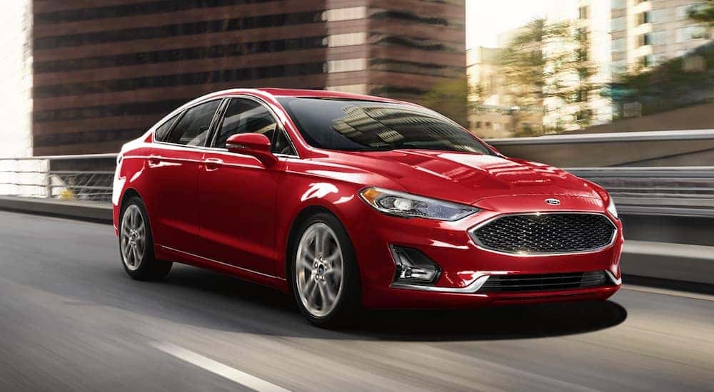A red 2020 Ford Fusion is shown leaving a used car dealer near Noblesville.