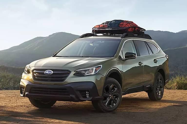 2022 Subaru Outback parked with a mountain range background