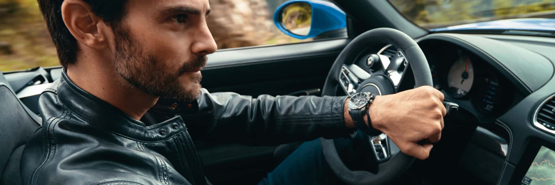 2025-porche-718-boxster-interior-and-a-man-in-a-leather-jacket-at-the-steering-wheel