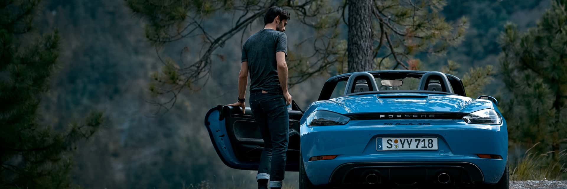 2025-porche-718-boxster-GTS-with-a-man-opening-the-door-and-getting-inside