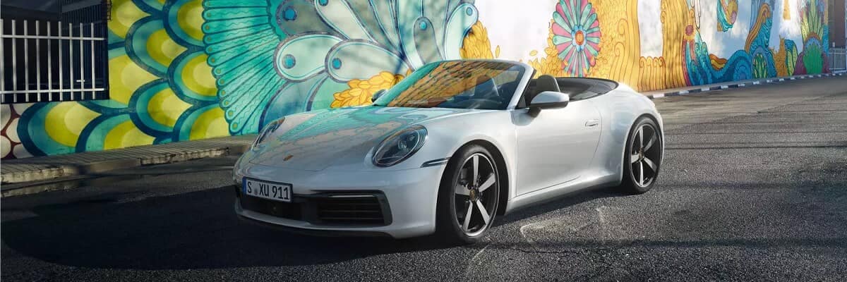 Porsche 911 Grey parked in front of street art