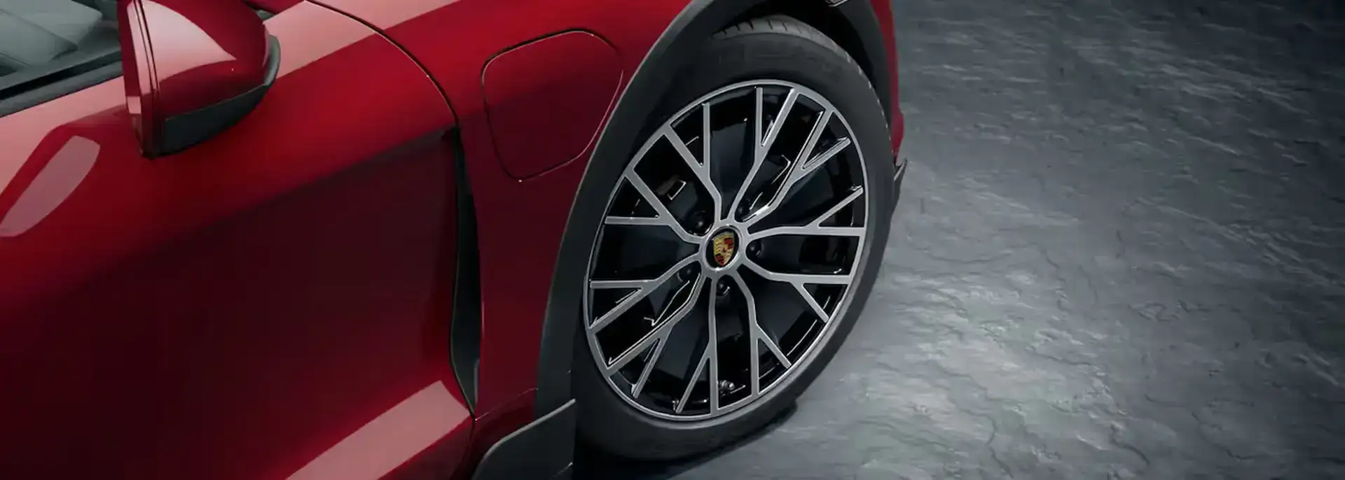 Angled view of a red Porsche and car tire
