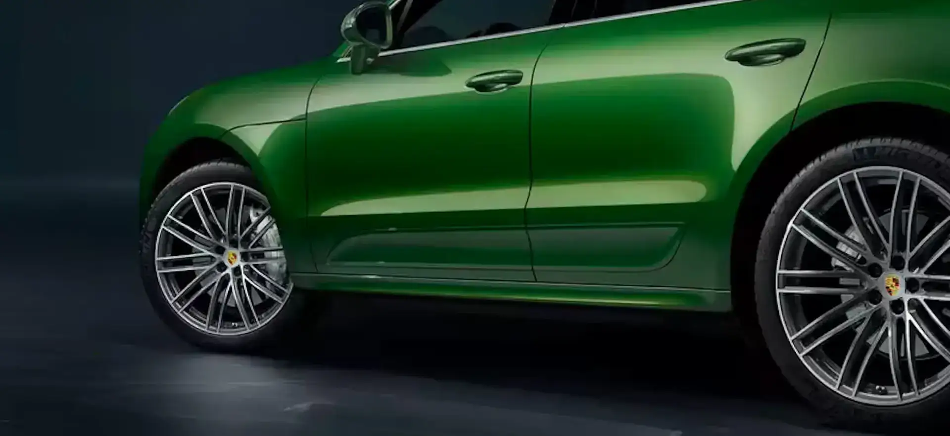 Close up sideview of a green Porsche