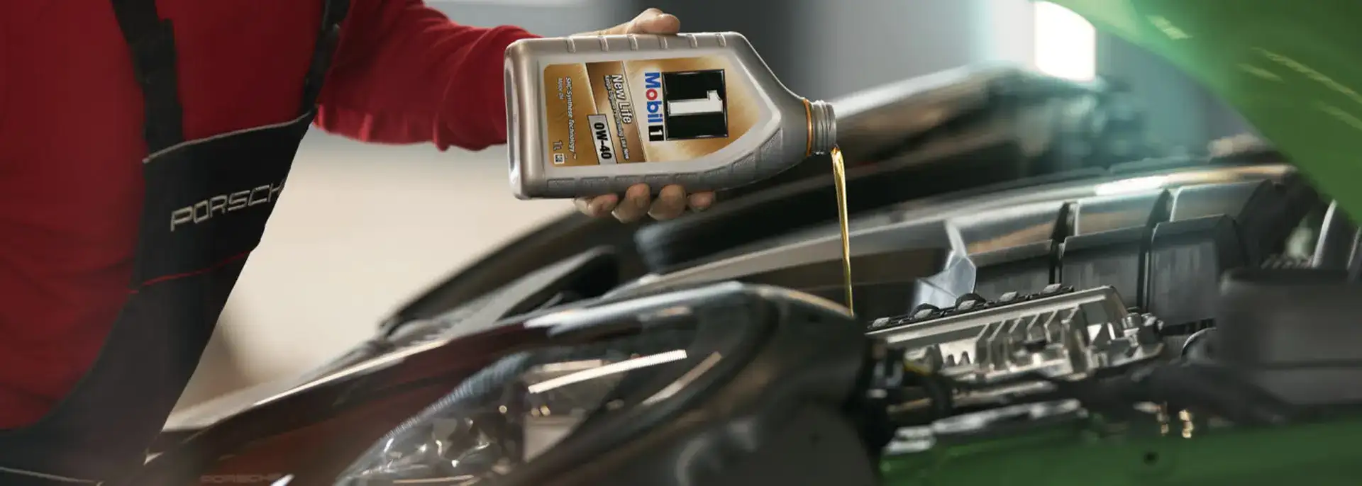 Mechanic pouring car oil