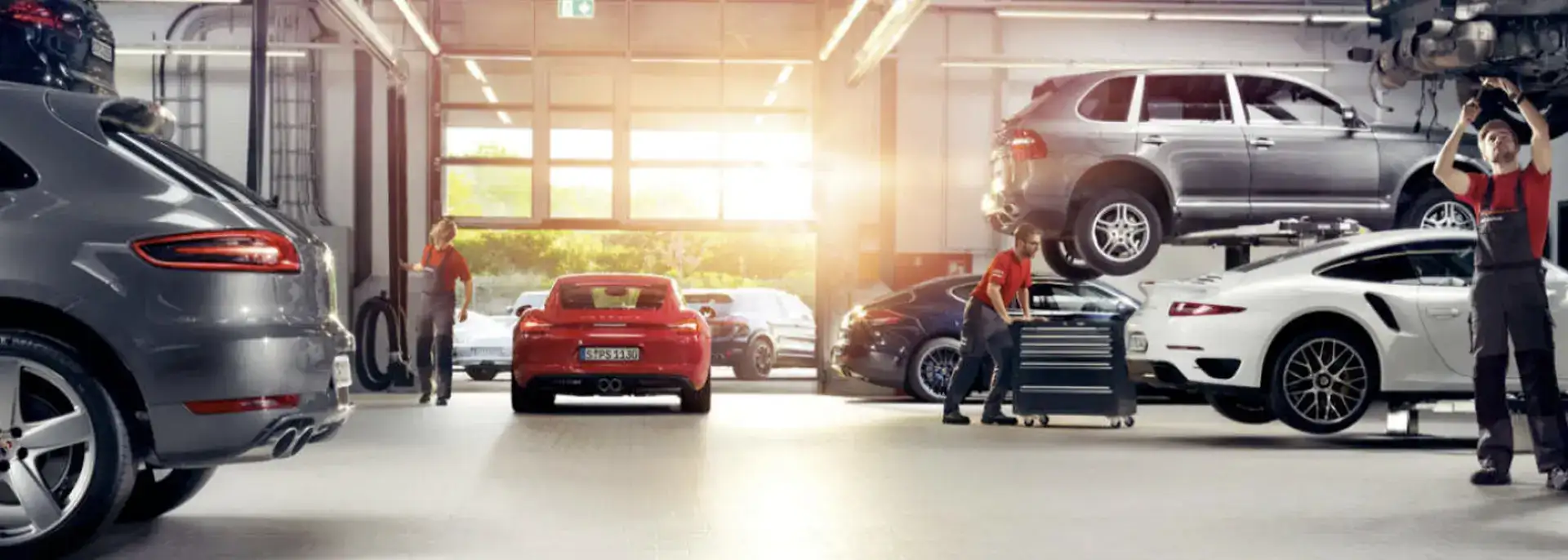 Porsche service center with Mechanics and Porsche vehicles