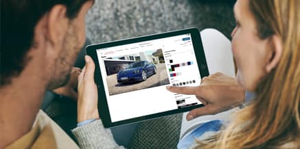 People designing their Porsche on a tablet