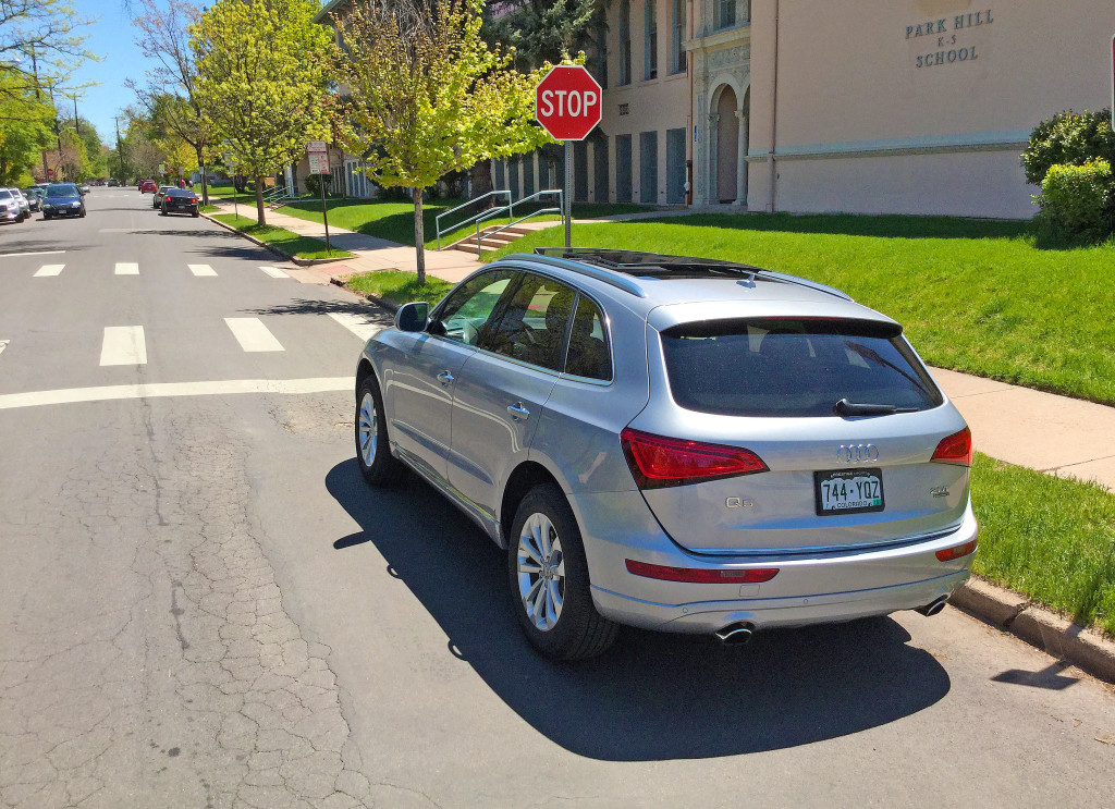 An Audi Q5 parked in front of the historic Park Hill Elementary School at 19th and Elm in Denver