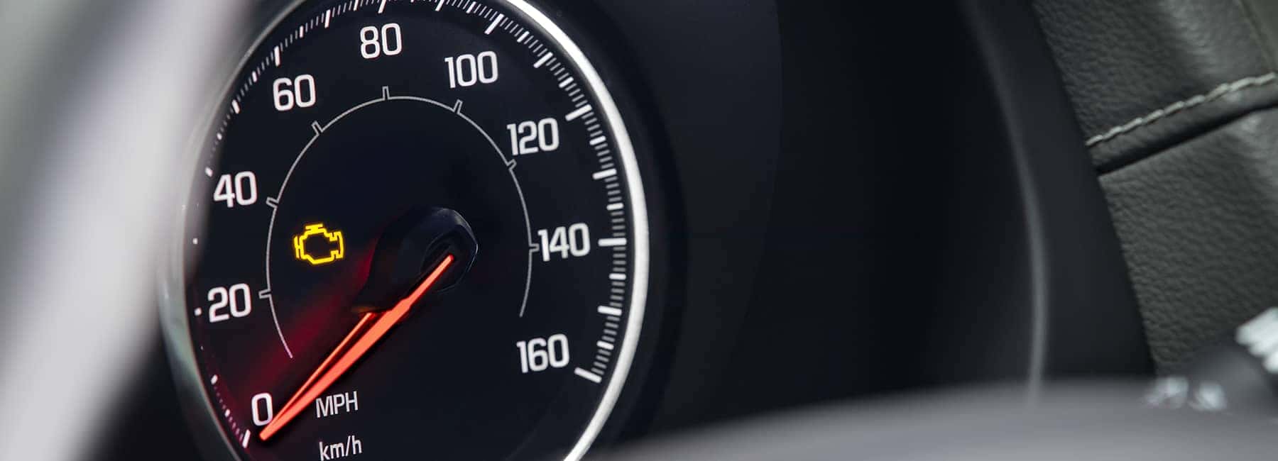closeup of check engine light in dashboard