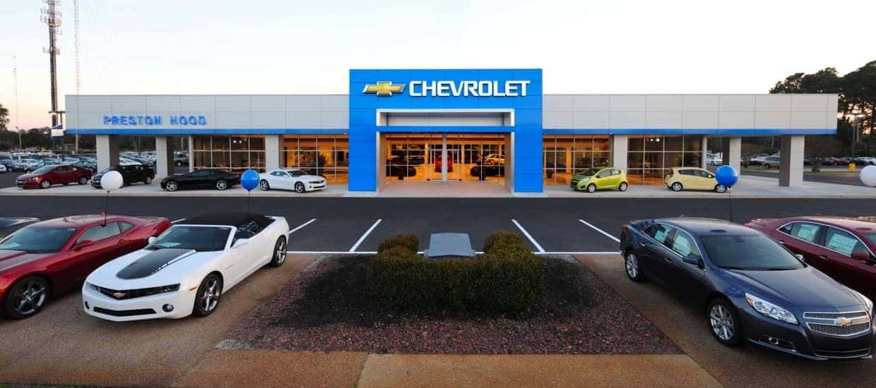 An exterior shot of a Chevrolet dealership at night.