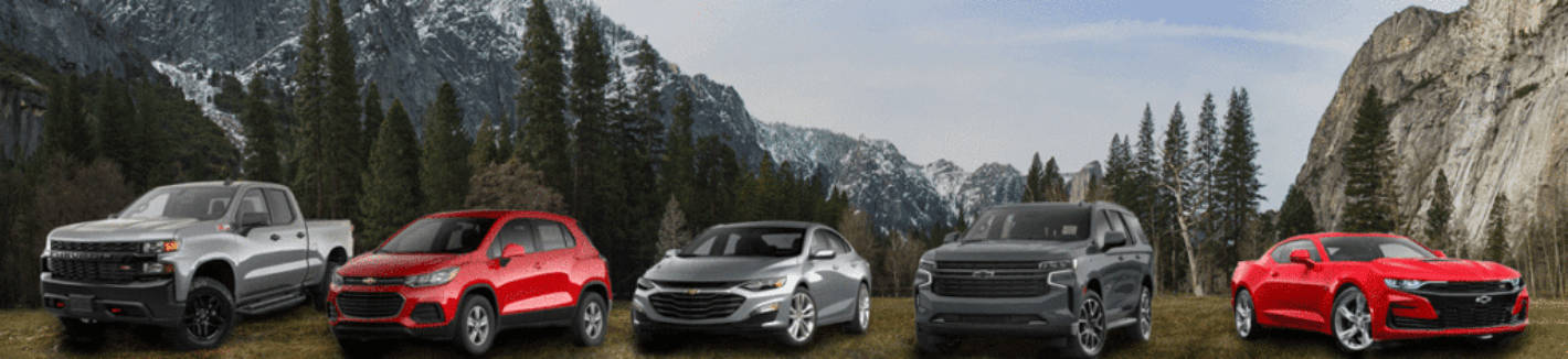 Chevrolet Vehicles parked with mountains in background