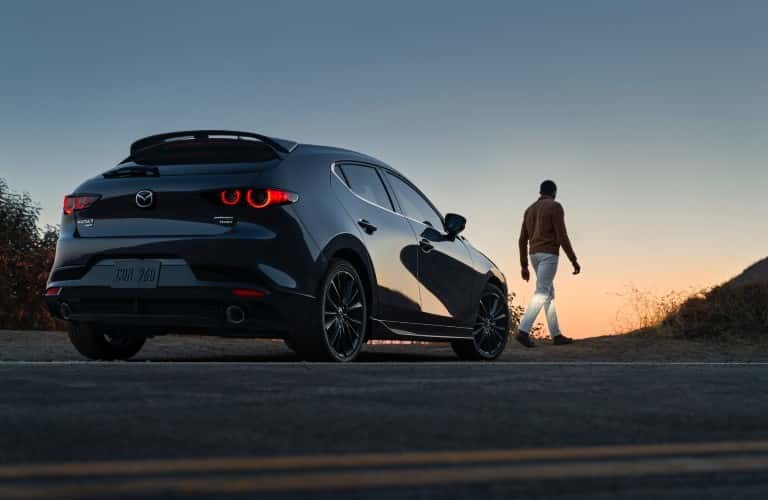 person walking near 2021 Mazda3 2.5 Turbo
