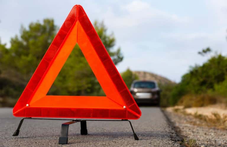 orange hazard sign on road