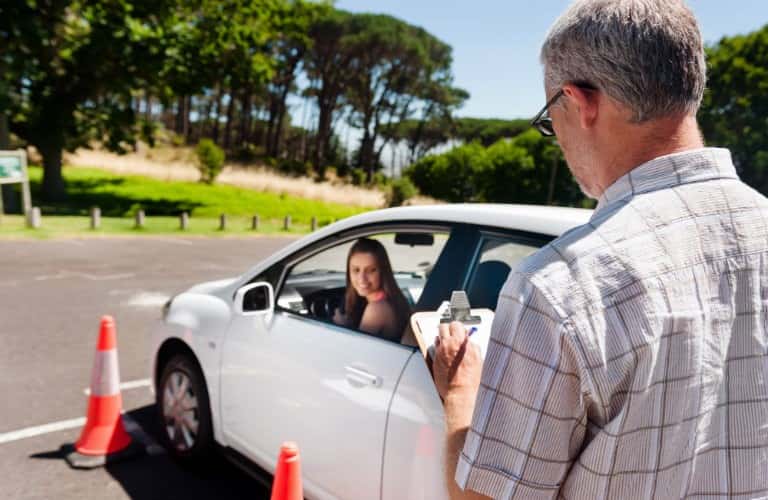 female driving as male instructor grades her