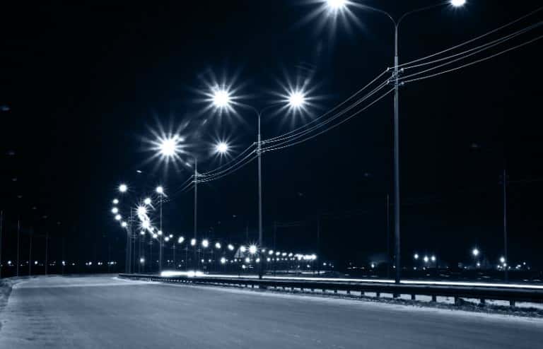 empty road at night with streetlights on