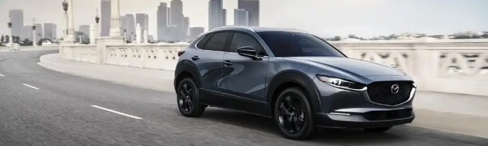 2021 Mazda CX-30 2.5 Turbo driving away from city