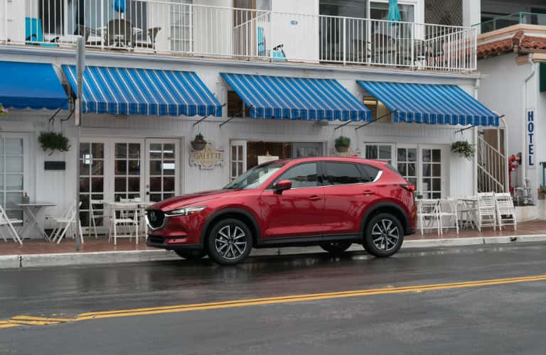 red mazda cx5 parked on side of road