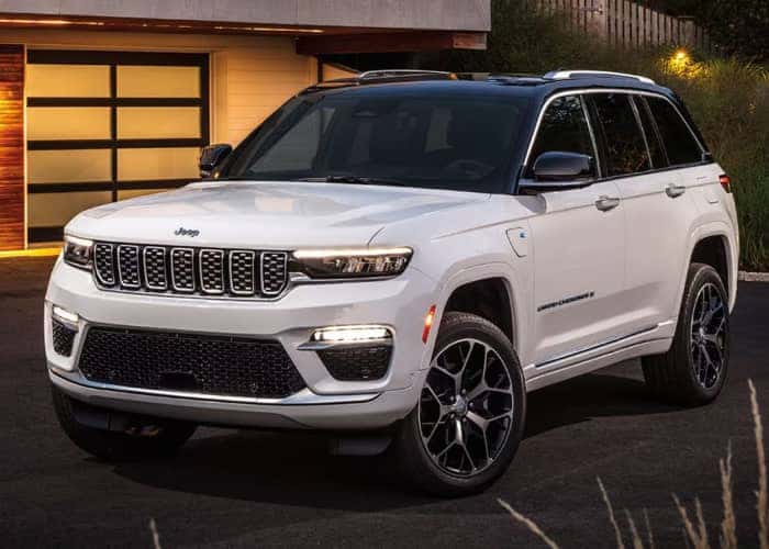 offers incentives white Jeep parked by home garage