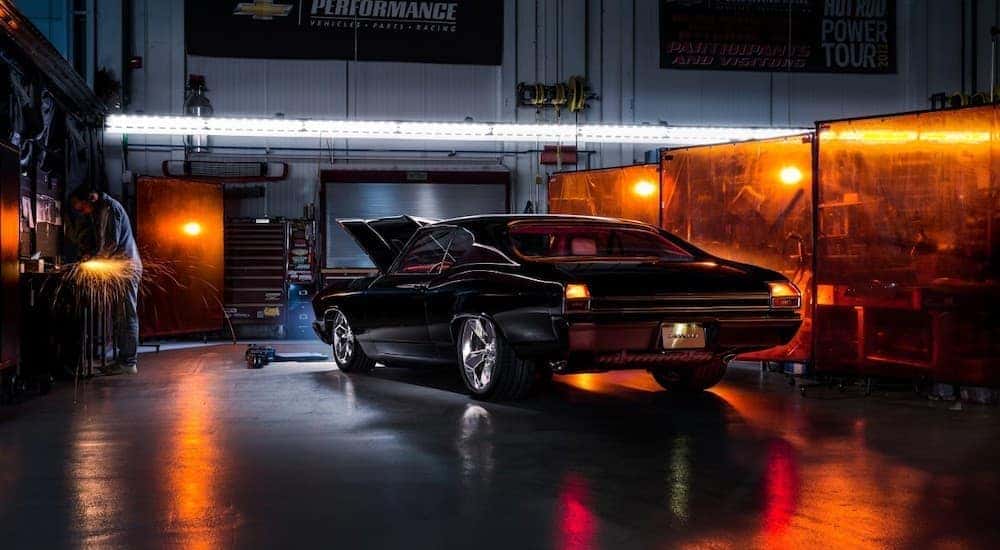 A black Chevelle concept build is parked in a dark garage near a Chevy dealer in Bethlehem, PA.