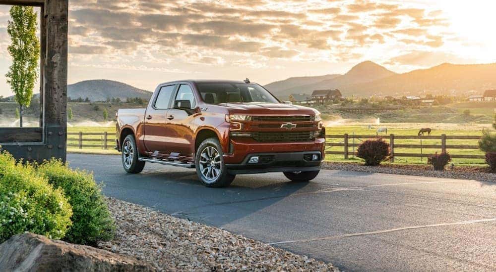 A red 2020 Chevy Silverado 1500 is parked in a driveway with a sunset in the background near Bethlehem, PA.