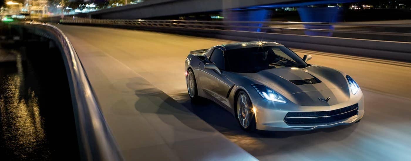 A silver 2019 Chevy Corvette Stingray is driving on a highway at night near Bethlehem, PA.