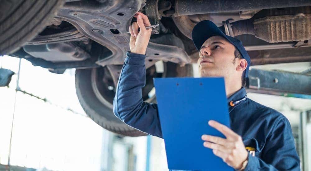 A Bethlehem, PA, mechanic is doing an inspection under a car.