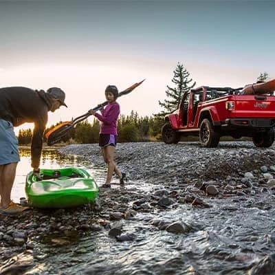 Family at a lake with their Jeep