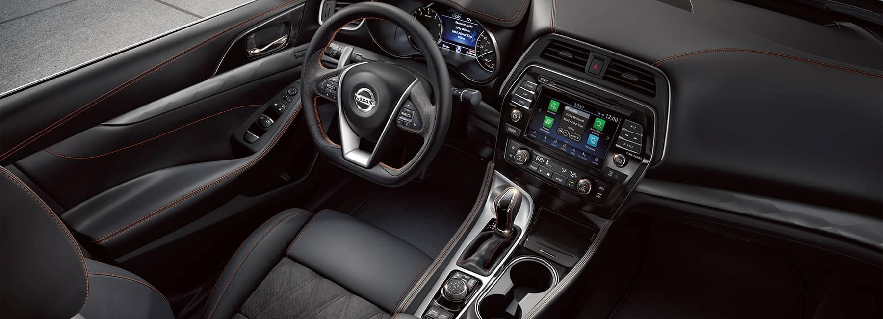The black leather driver's seat and dashboard of a 2021 Nissan Maxima