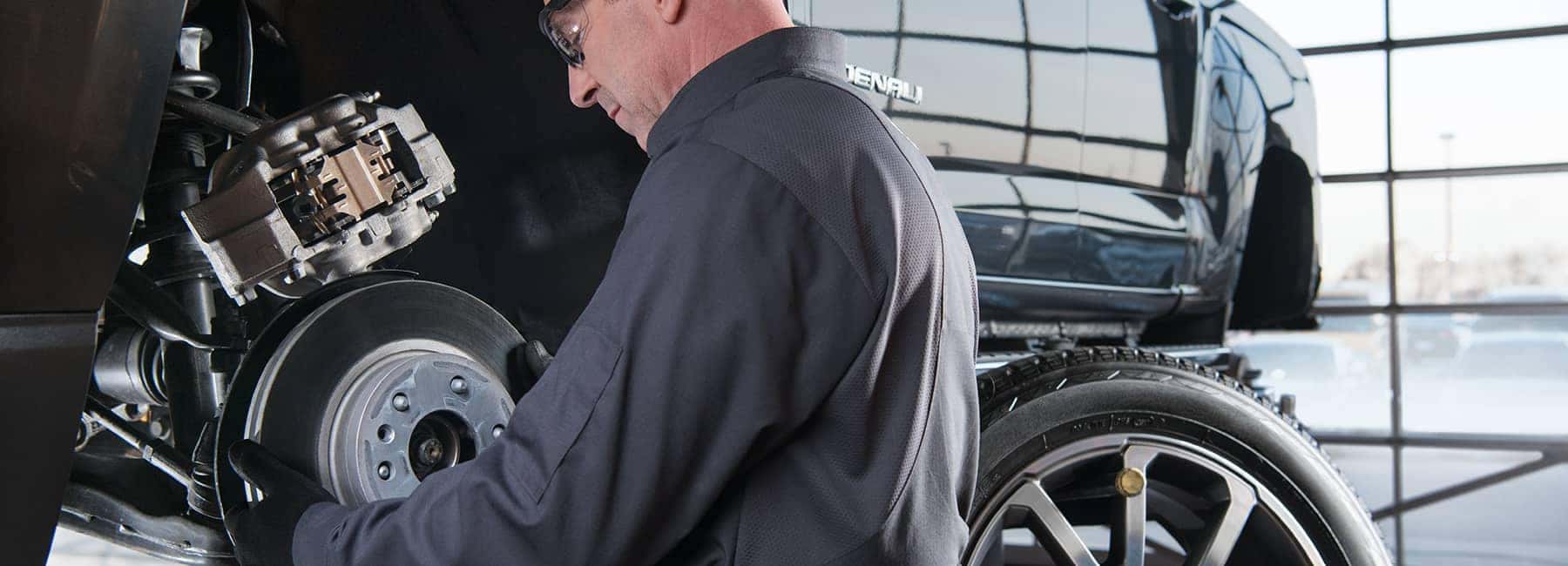 GMC Service Technician Working on Rotors and Brakes