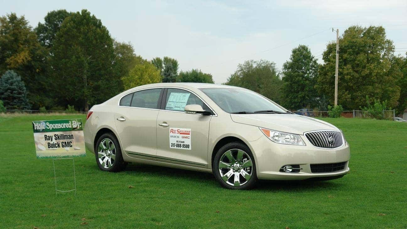A photo of a sedan on a golf course