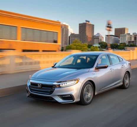 Honda sedan driving on a city street