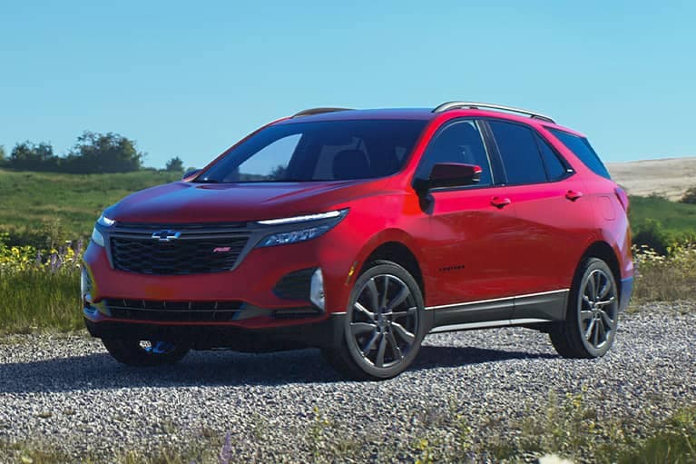 2023 Red Chevrolet Equinox parked on a gravel road in a field_mobile