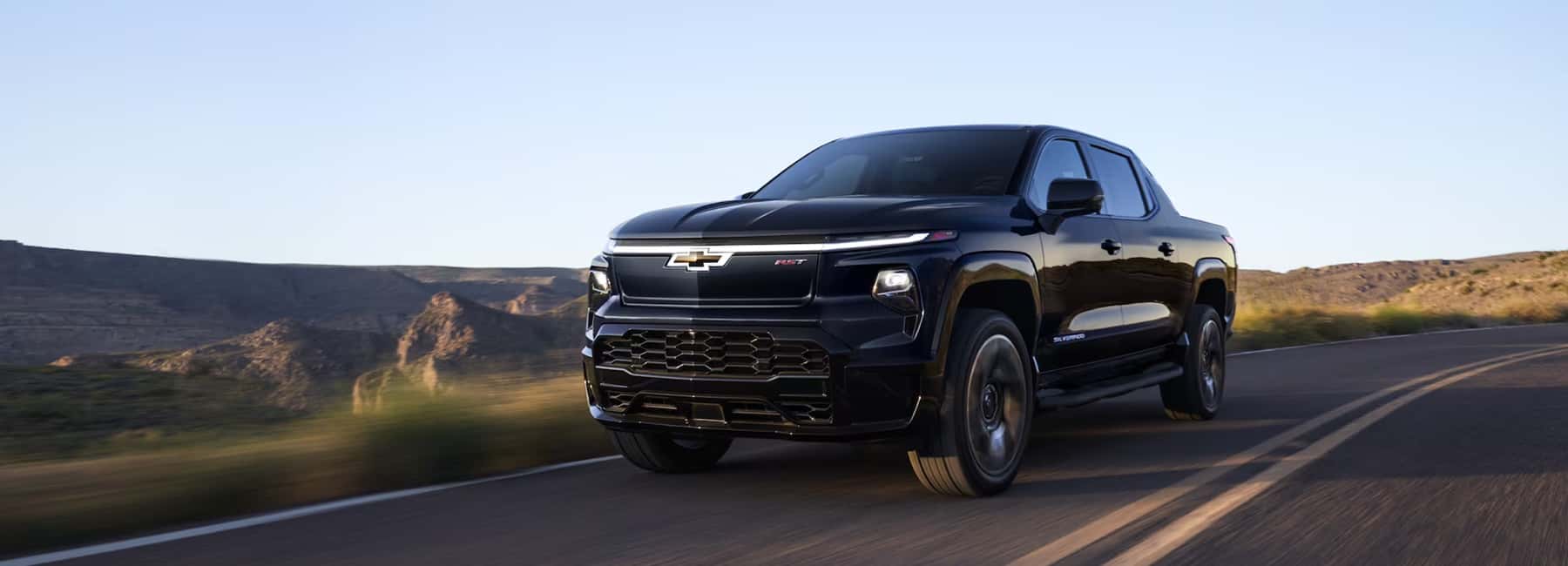 2025-Silverado-EV driving turning highway road