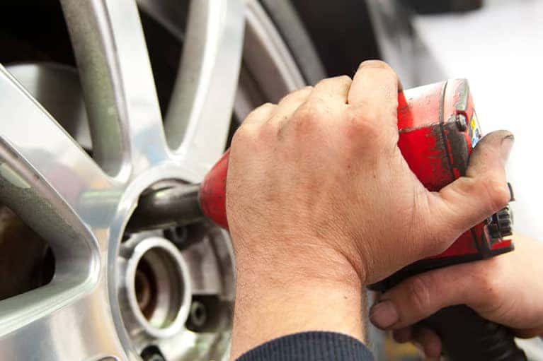 mechanic putting on a tire