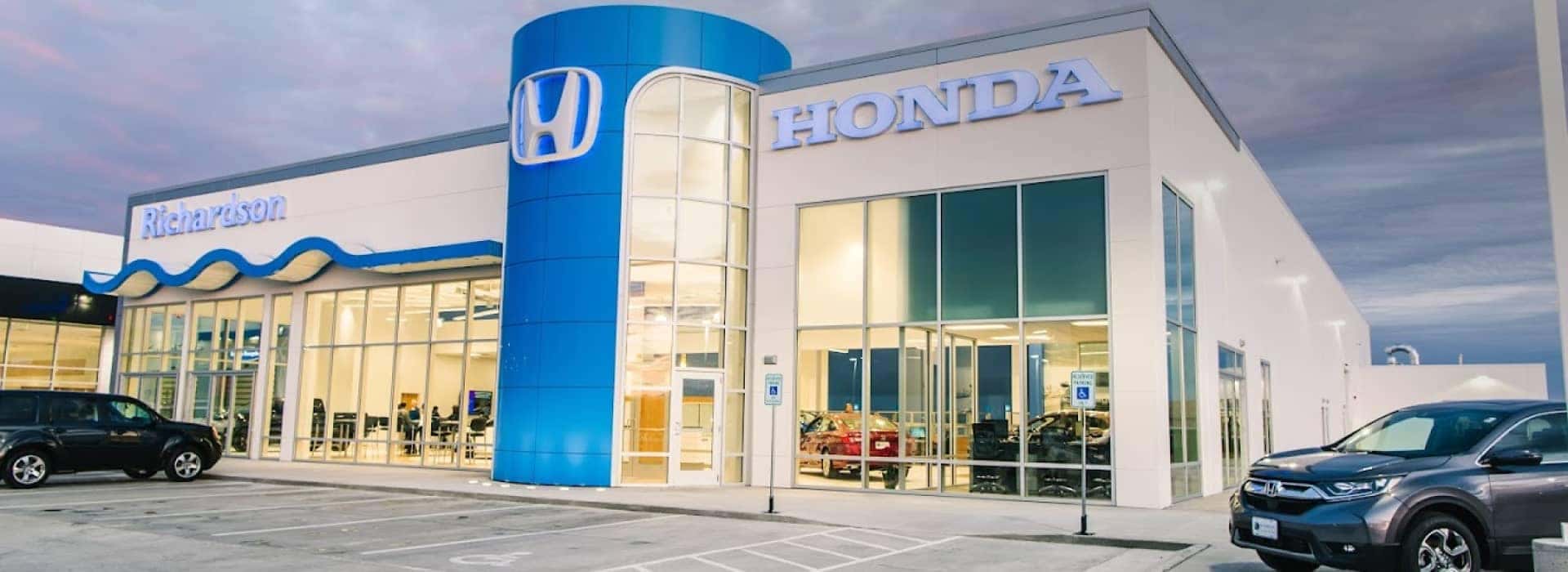 An exterior shot of a Richardson Honda dealership with a cloudy sky.