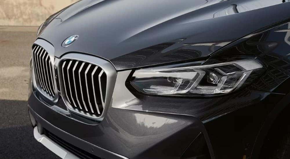 A close up shows the front end of a grey 2024 BMW X3 after visiting a BMW dealer.