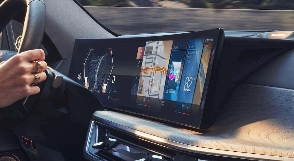 The curved infotainment and digital driver display in a 2024 BMW.