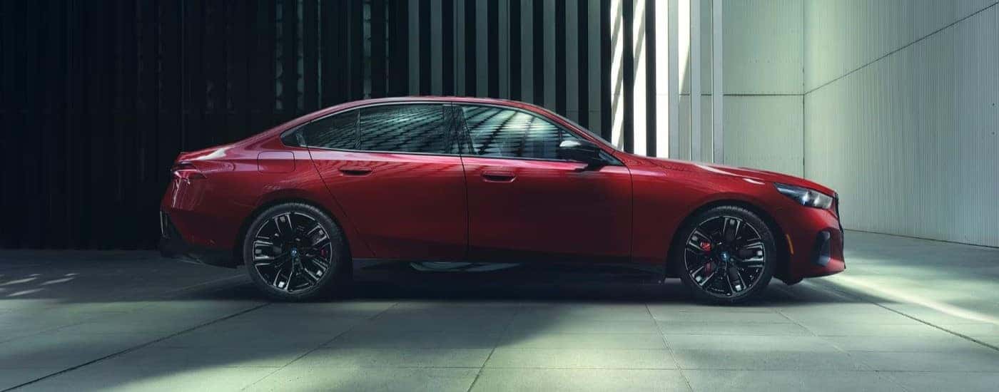A red 2024 BMW i5 M60 is shown from the side.