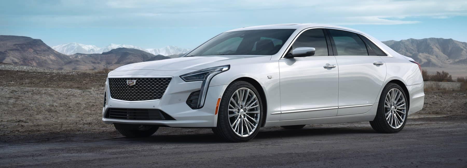 2020 Cadillac CT6 driving down road with mountains in background