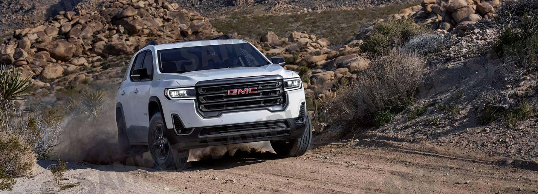 White 2020 GMC Acadia on a Gravel Rd