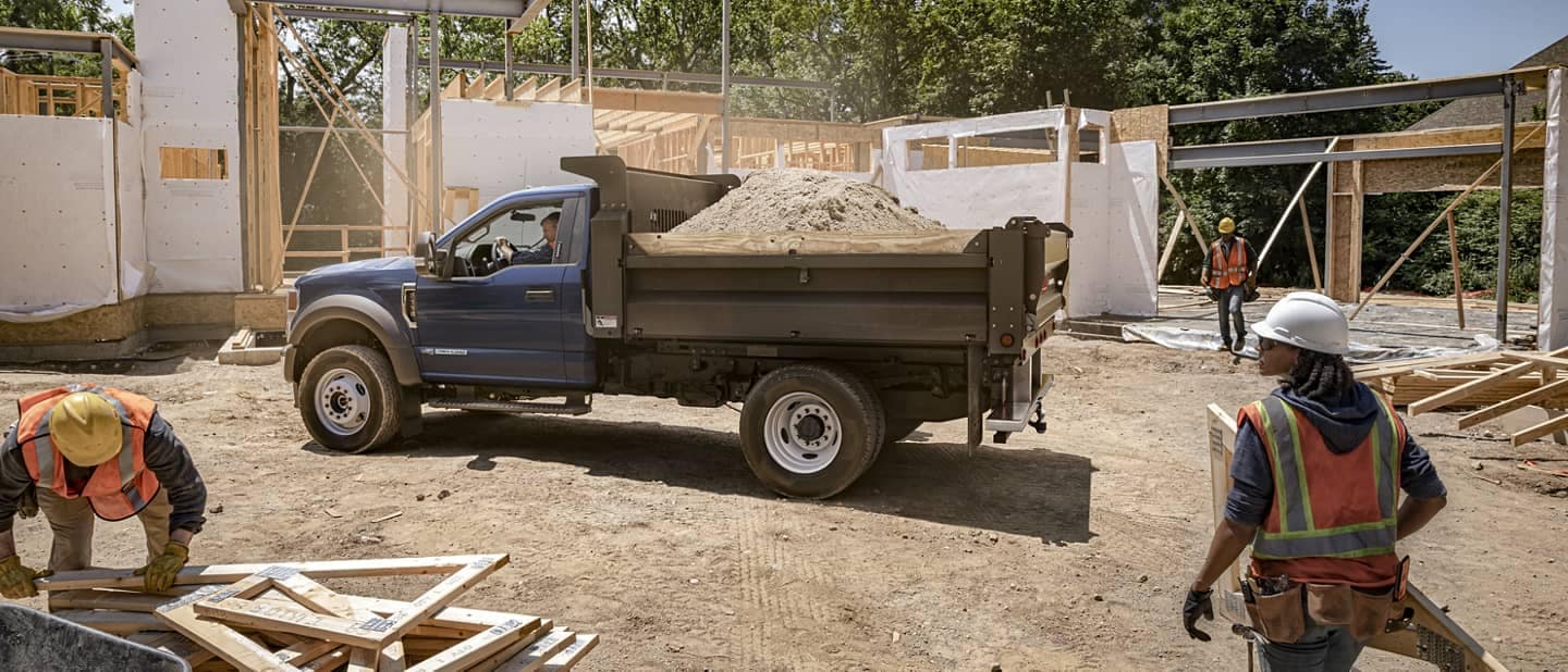Ford Cutaway dump truck filled with dirt at construction site