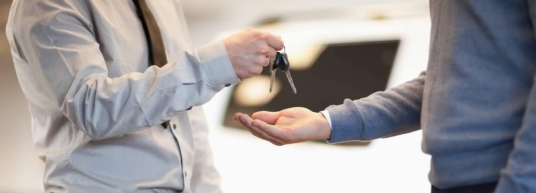 Salesman Handing Car Keys to Man